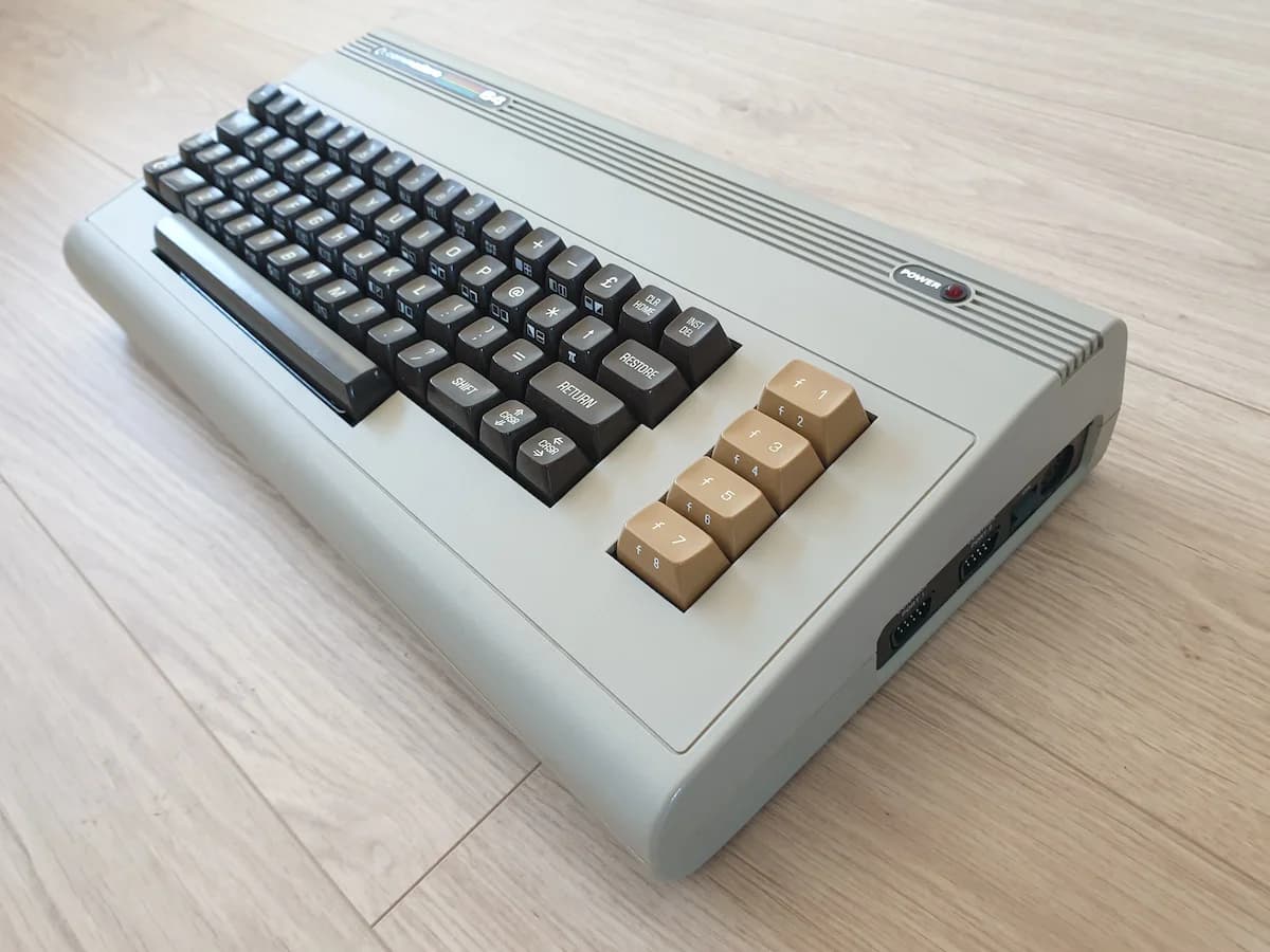 Commodore 64 breadbin viewed from an angle, showing the rounded case design and full-width keyboard