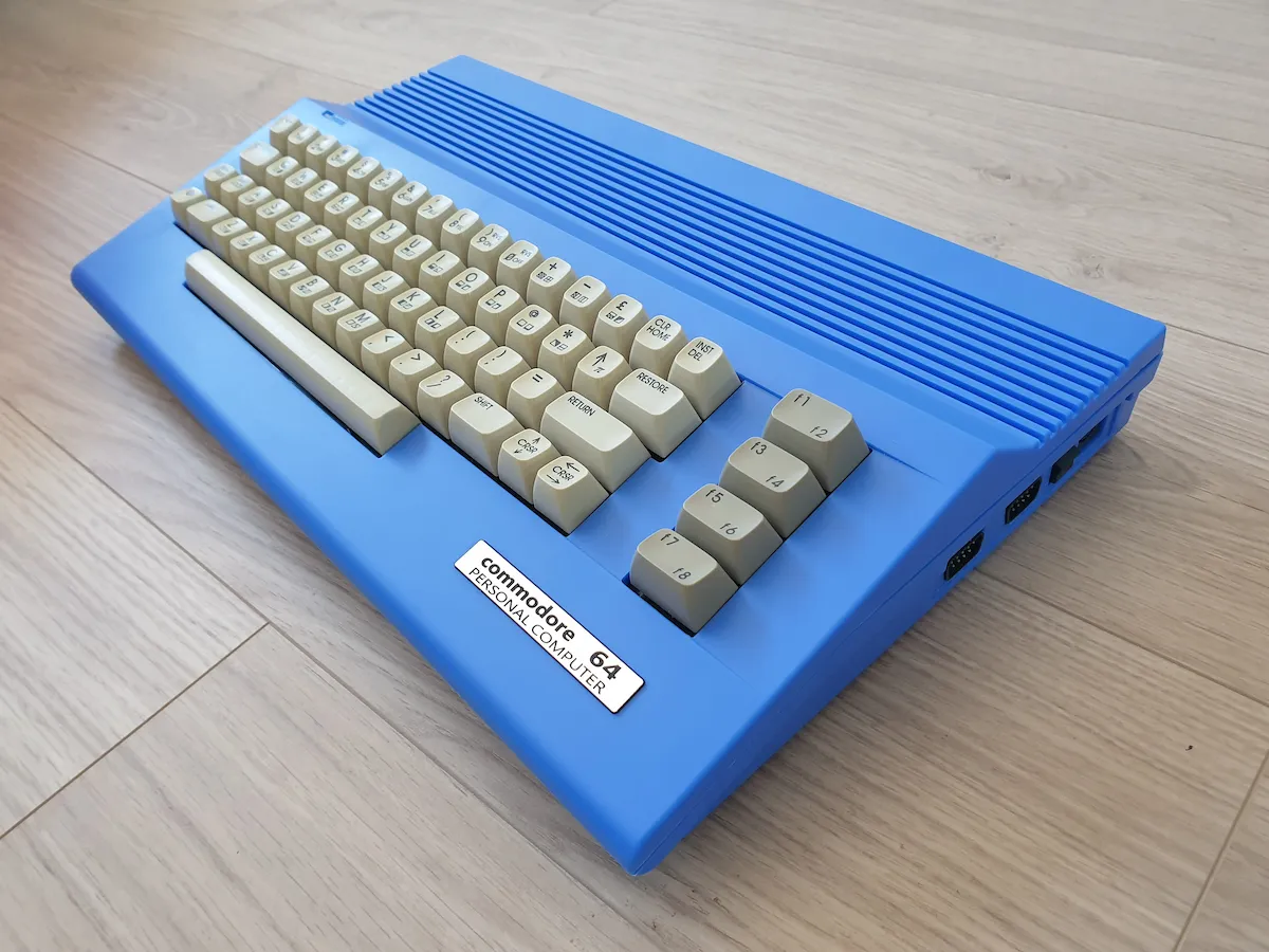 Blue Commodore 64C, angled view showing the vivid blue housing
