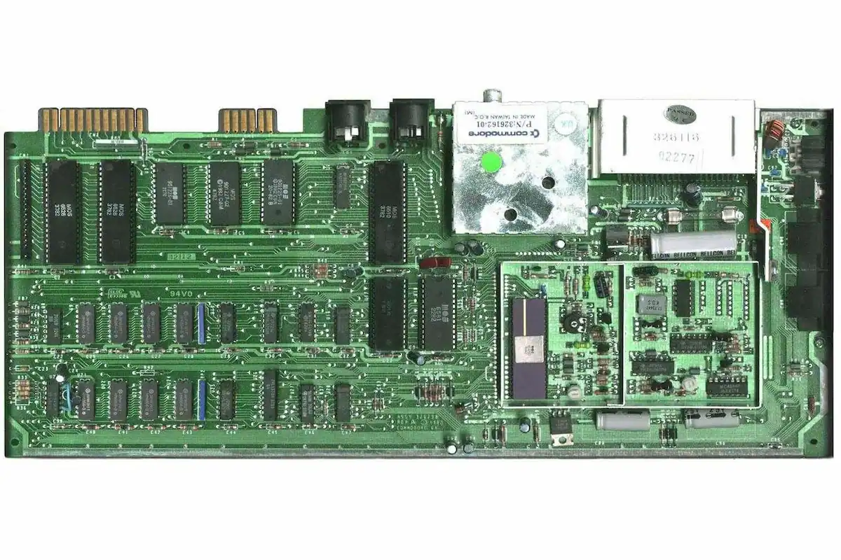 Commodore 64 PAL motherboard showing the MOS 6569 VIC-II graphics chip alongside the SID and CPU